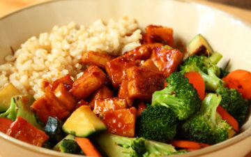 A bowl of Teriyaki Peanut Tofu with Stir-Fried Veggies & Brown Rice.