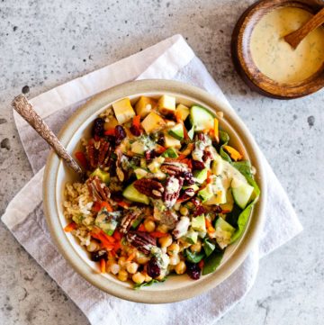 Vegan Goddess Bowl with Tahini Dressing on a concrete background.